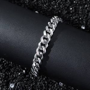 Classic 8mm silver stainless steel cuban chain bracelet on a black textured display