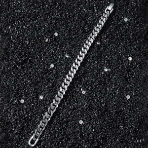 Classic 8mm silver stainless steel Cuban link bracelet on a textured black background