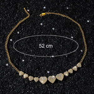 Detail view of gold-plated necklace with sparkling heart pendants and 52 cm length mark