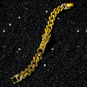 Macro detail of St. Jude religious pendant on a gold cuban link chain with zircon clasp