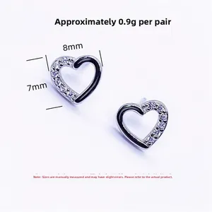 Macro detail of S925 sterling silver heart earrings measuring 8mm by 7mm with micro zircons
