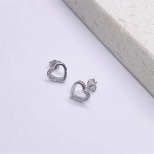 Macro shot of S925 sterling silver heart earrings with sparkling cubic zirconia pavé setting
