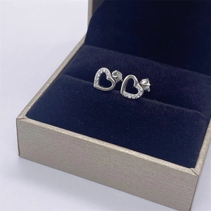 Macro shot of S925 sterling silver heart studs with cubic zirconia in a jewelry box