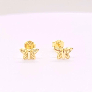 Macro detail of S925 sterling silver stamp on golden butterfly stud earrings