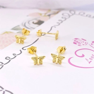 Detailed macro view of S925 sterling silver gold-plated butterfly stud earrings with hallmark
