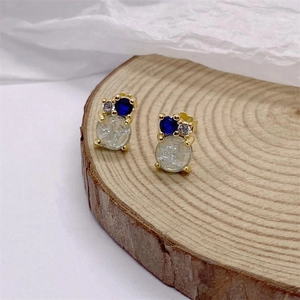 S925 sterling silver earrings with blue and crackle stones on wooden stand