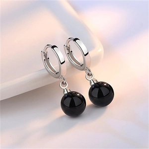 Elegant S925 sterling silver drop earrings with polished black onyx beads on white stand