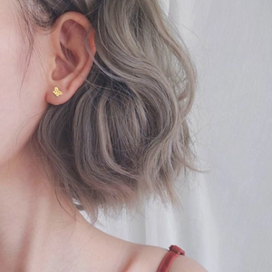 Minimalist gold butterfly stud earrings in S925 sterling silver worn by a model