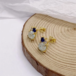 Elegant gold snowman studs with sparkling crystals and blue stones on wood base