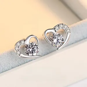 Macro shot of S925 sterling silver heart stud earrings with sparkling round center stone