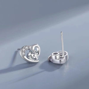 Macro shot of S925 sterling silver heart earrings with sparkling cubic zirconia detail