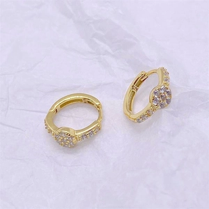 Macro shot showing 925 hallmark stamp on minimalist gold-plated silver zircon earrings