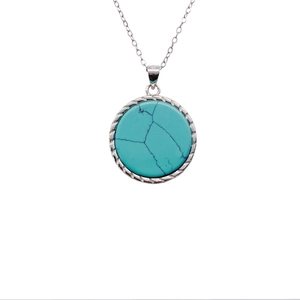 Macro detail of S925 sterling silver stamp on vintage turquoise circle pendant necklace
