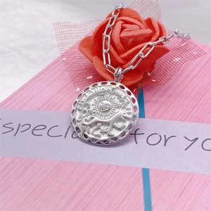 S925 sterling silver sun and dog relief pendant necklace shown in a pink gift box