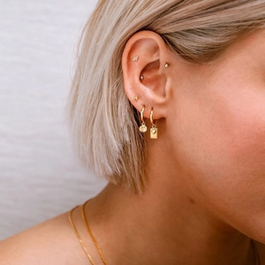 Bohemian gold S925 silver starburst hoop earrings and necklace set on female model