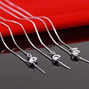 Adjustable S925 sterling silver box chain necklaces with needle tips shown on black background
