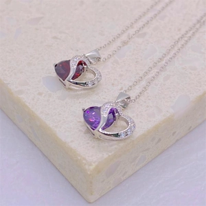 S925 silver heart necklaces with purple and red gems on a stone background