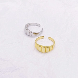 Detail view of gold and silver S925 sterling silver rings with vertical striped texture