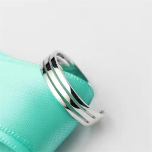 Elegant 925 sterling silver open toe ring with hollow design on blue silk fabric