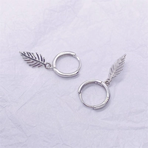 Detailed close-up showing the S925 hallmark on silver hoop earrings with leaf pendants