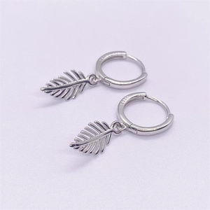 Close-up of S925 sterling silver leaf earrings showing detailed texture and S925 stamp
