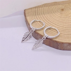 Detailed view of leaf earrings showing the S925 hallmark and fine silver textures