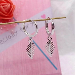 Elegant S925 sterling silver leaf drop hoop earrings displayed on a gift-themed stand