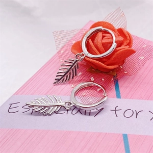 S925 sterling silver leaf drop hoop earrings displayed on a gift box with floral decor