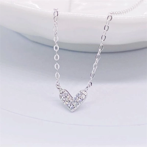 Macro shot of S925 sterling silver heart pendant with pavé cubic zirconia inlay