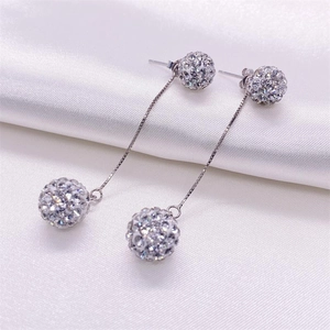 Macro detail of S925 sterling silver long tassel earrings with sparkling crystal balls