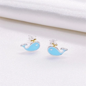Cute S925 sterling silver blue whale stud earrings on a luxurious white silk background
