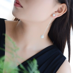 Macro shot of S925 sterling silver long tassel earrings with sparkling crystal pavé balls