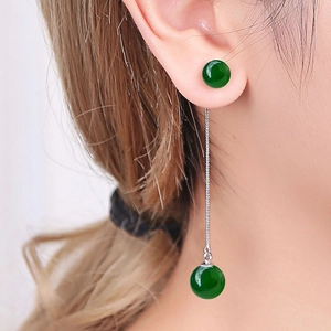 Macro detail of S925 silver long tassel earrings with green agate beads on model