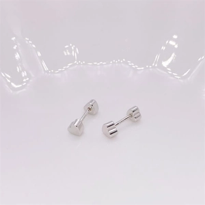 Macro detail of S925 sterling silver heart screw back studs with authentic hallmark