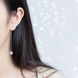 Detail of elegant S925 sterling silver ear thread with translucent cat eye stone beads