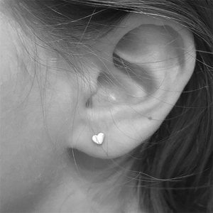 Minimalist S925 sterling silver heart screw stud earrings worn on female ear model