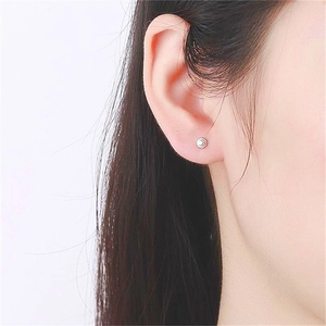 Minimalist S925 sterling silver dumbbell screw stud earrings worn by a model