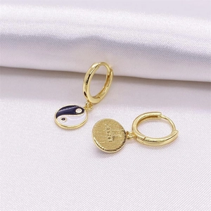 S925 sterling silver gold plated Tai Chi Yin Yang hoop earrings on white silk fabric