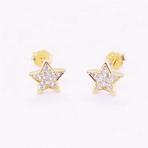 Close-up of S925 sterling silver stamp on gold star stud earrings with purple crystals