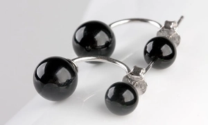 Macro shot showing S925 sterling silver stamp and polished black onyx bead earrings