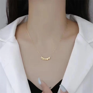 Minimalist S925 sterling silver gold-plated necklace with five polished beads worn by model