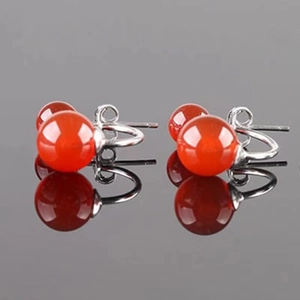 Macro shot of S925 sterling silver studs with round red agate stones and butterfly backs