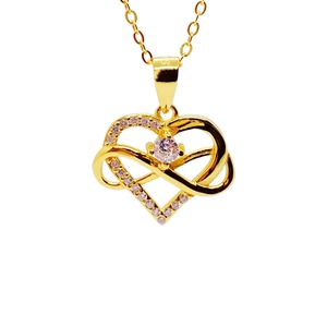 Macro shot of gold-plated S925 silver heart necklace with infinity symbol and crystals