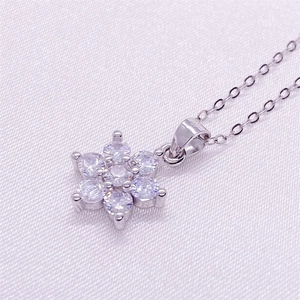 Macro shot of S925 sterling silver snowflake pendant with sparkling zircon gemstones