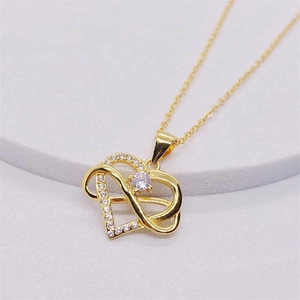 Macro detail of gold S925 sterling silver heart and infinity pendant with pavé set zircon