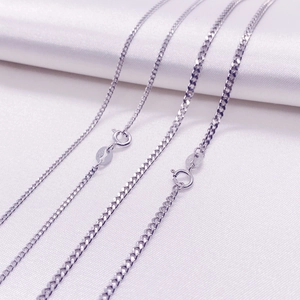 Polished S925 sterling silver curb chain necklaces on elegant white silk fabric