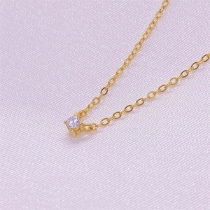 S925 sterling silver gold necklace with round purple zircon pendant on silk background