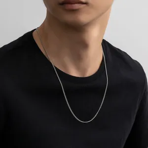 Close-up of minimalist S925 sterling silver Cuban link chain necklace on a male model