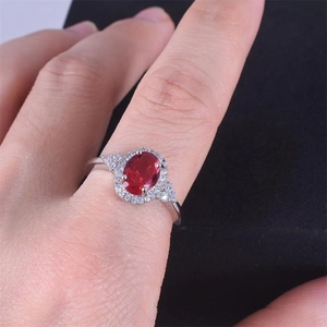 Detailed view of S925 silver ring featuring an oval red zircon stone on model finger