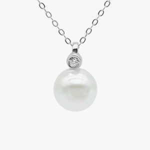 Macro shot of S925 sterling silver pearl necklace with sparkling diamond-set pendant